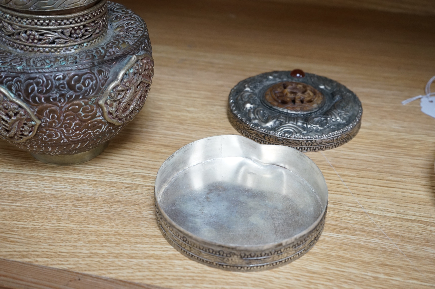 A Tibetan copper and brass pot and a similar box and cover with mirrored interior, largest 19cm high (2). Condition - poor to fair